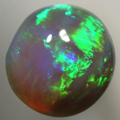 SOLID BLACK CRYSTAL OPAL Bright greens rolling flashes over a high dome